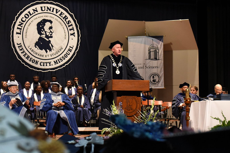 Lincoln University President John Moseley stands at the podium giving a speech during graduation.