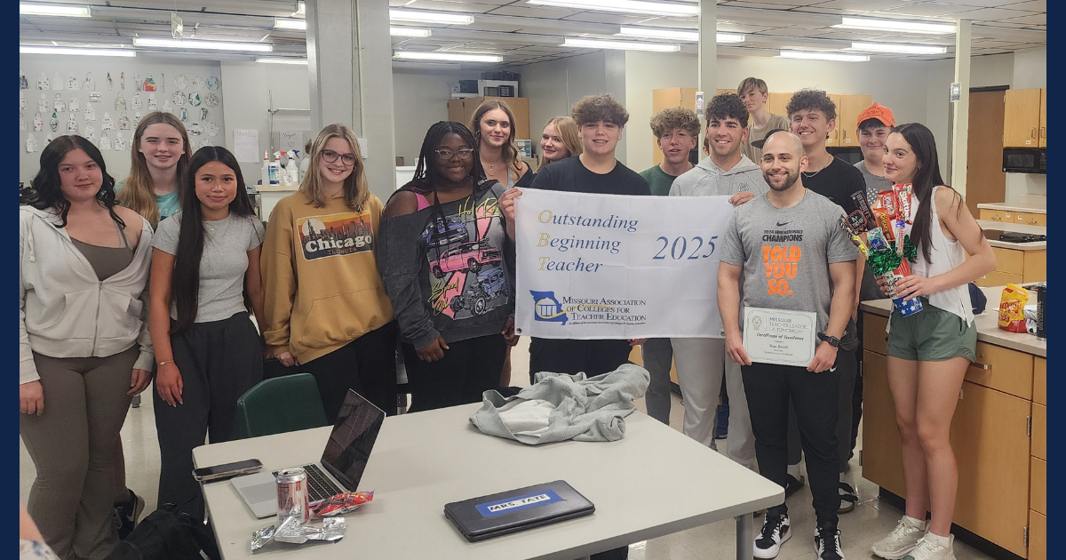 Lincoln University graduate Ross Barelli stands with his students in a classroom at Rock Bridge High School celebrating his win.