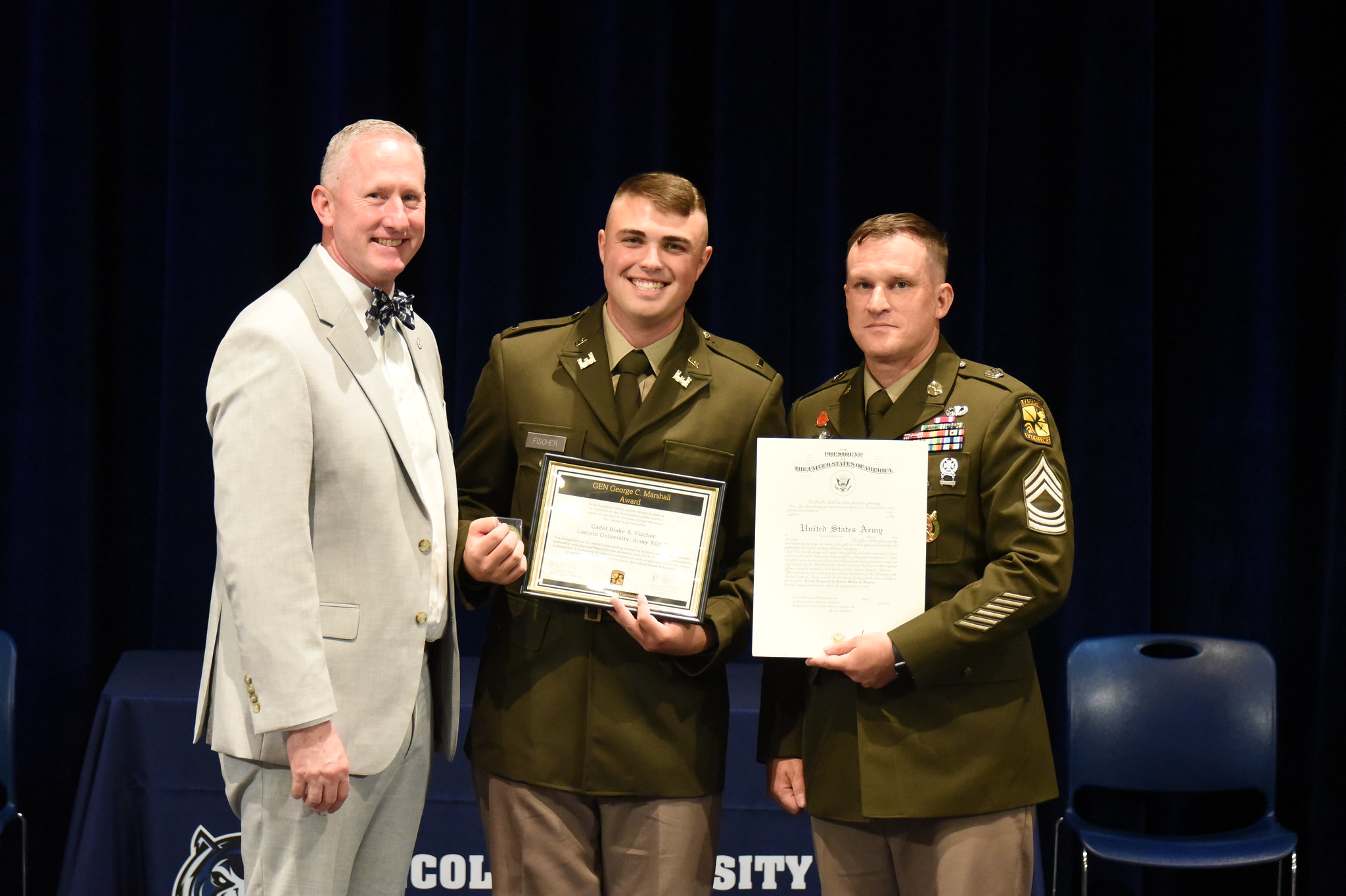 Cadet Blake Fischer was officially appointed as a second lieutenant in the U.S. Army during a commissioning ceremony on May 9. Left to right: Lincoln University President Dr. John B. Mosley, Cadet Blake Fischer and MSG Timothy Morningstar stand in a row on the stage. 